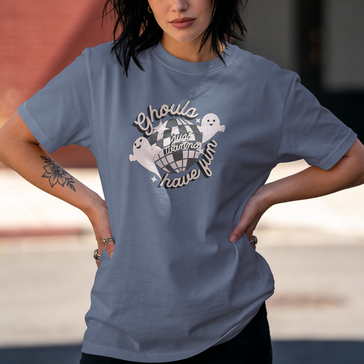 Blue Jean Comfort Colors T-shirt with two smiling ghosts, a distressed disco ball, and cream retro lettering reading “Ghouls just wanna have fun.”